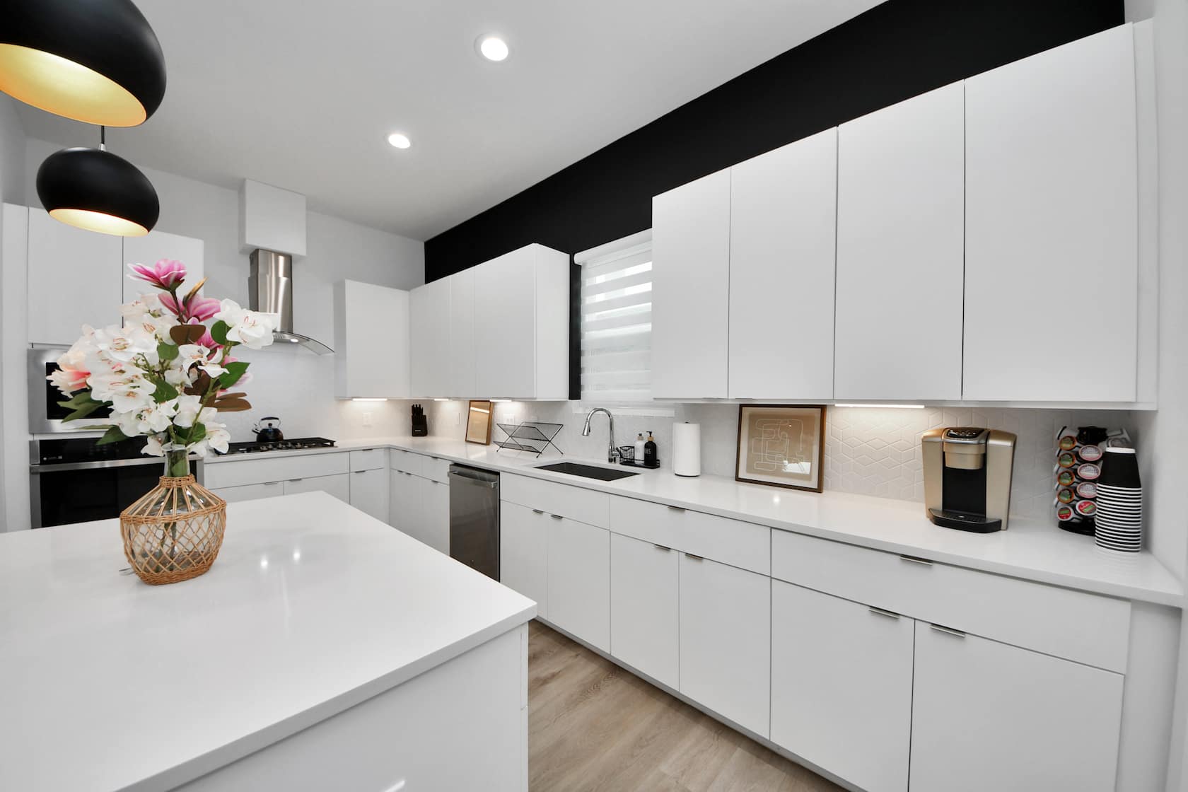 Kitchen with white cabinetry, an island and stainless appliances