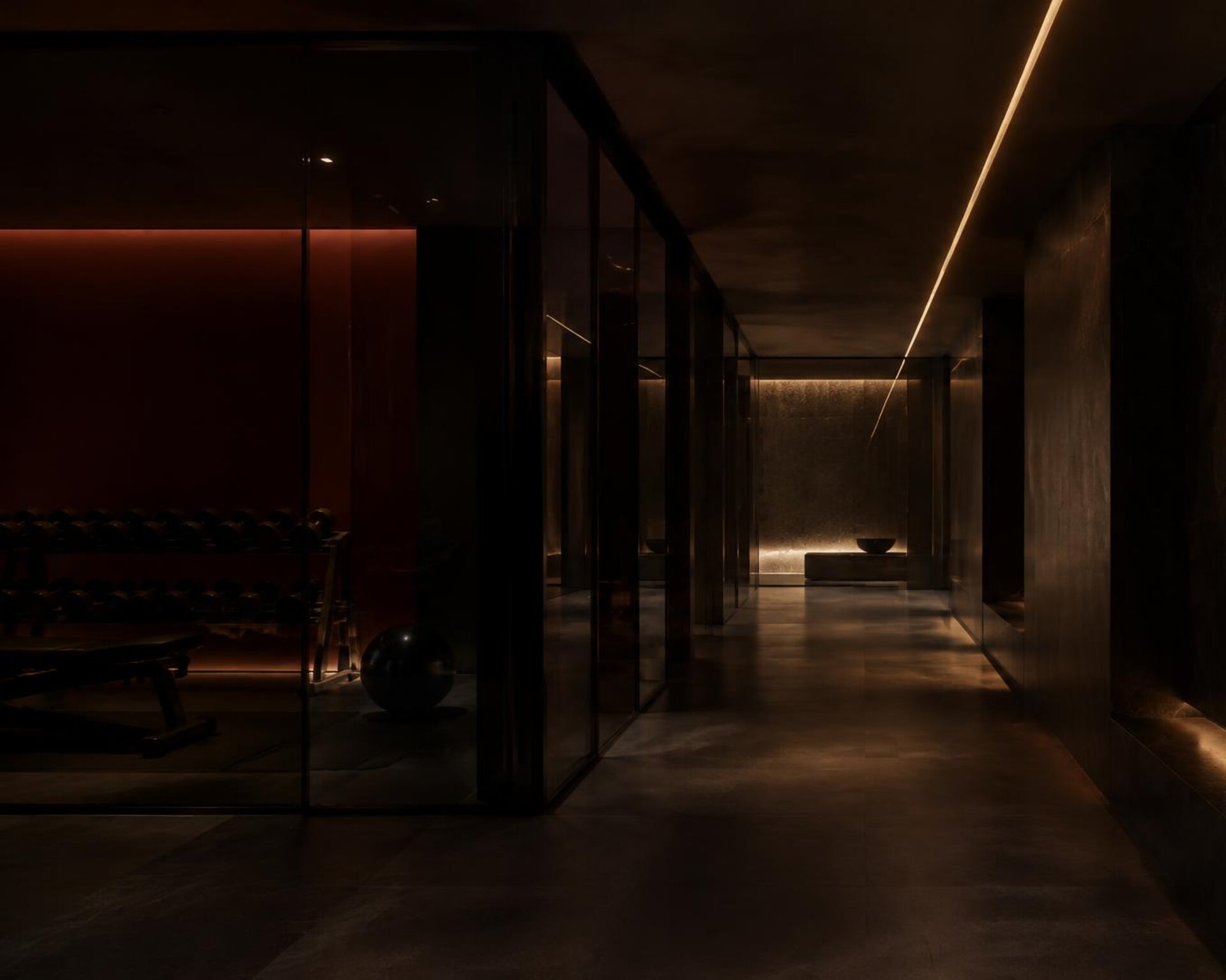 Dark stone corridor with a single line of amber light